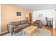 Cozy living room featuring a comfortable sofa, chair, hardwood floors and a large picture window at 1732 Lansing St, Aurora, CO 80010