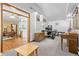 Open office area with desk, chair, file cabinet, and adjacent living space with hardwood floors at 1732 Lansing St, Aurora, CO 80010