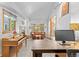 Bright home office boasts a piano, fireplace, brown sofa, and workspace with a monitor at 1732 Lansing St, Aurora, CO 80010