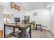 Well-lit office space featuring a large desk, shelving, and comfortable seating at 1732 Lansing St, Aurora, CO 80010