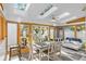 Light-filled sunroom with skylights, dining table, and comfortable seating area at 1732 Lansing St, Aurora, CO 80010