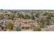 Aerial view showcasing a multi-story townhome complex nestled among mature trees at 6001 S Yosemite St # F207, Greenwood Village, CO 80111