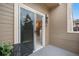 Balcony with sliding glass door entry showcasing outdoor space, a small table, and views of a nearby tree at 6001 S Yosemite St # F207, Greenwood Village, CO 80111