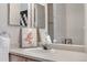 Bright bathroom featuring a vanity with a modern faucet and decoratively framed mirror above the sink at 6001 S Yosemite St # F207, Greenwood Village, CO 80111
