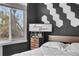 Bedroom with large window, and bed with stylish accent wall at 6001 S Yosemite St # F207, Greenwood Village, CO 80111