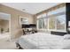 Bedroom with neutral walls, a large window for natural light, and a computer setup making it a functional space at 6001 S Yosemite St # F207, Greenwood Village, CO 80111