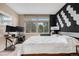 Bright bedroom features a large window with a view, accent wall and desk at 6001 S Yosemite St # F207, Greenwood Village, CO 80111