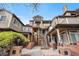 Multi-story condo building featuring a landscaped entrance with brick accents leading up to the units at 6001 S Yosemite St # F207, Greenwood Village, CO 80111