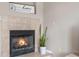 A cozy fireplace with tile surround and decorative plant in the living area at 6001 S Yosemite St # F207, Greenwood Village, CO 80111