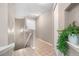 Hallway with tile flooring, pot light, and view of the front door and stairs at 6001 S Yosemite St # F207, Greenwood Village, CO 80111