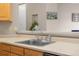 Kitchen sink features modern fixtures, breakfast bar and view into other living areas at 6001 S Yosemite St # F207, Greenwood Village, CO 80111