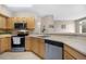 Functional kitchen with stainless steel appliances and an open layout at 6001 S Yosemite St # F207, Greenwood Village, CO 80111