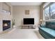 Relaxing living area with a warm fireplace and a large TV for entertainment at 6001 S Yosemite St # F207, Greenwood Village, CO 80111