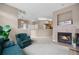 Spacious open-concept layout with a fireplace, comfortable seating, and open kitchen at 6001 S Yosemite St # F207, Greenwood Village, CO 80111