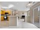 Bright living space adjoining kitchen, featuring natural light and access to a balcony at 6001 S Yosemite St # F207, Greenwood Village, CO 80111