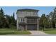 New construction home with grey horizontal siding, stone accents, balcony, 2-car garage and well manicured front lawn at 7728 S Cherokee Trl, Centennial, CO 80016