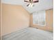 This is a view of a bedroom with carpet, a ceiling fan, and two windows letting in natural light at 7323 Lowell Blvd, Westminster, CO 80030