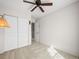 This is a view of the carpeted bedroom with a ceiling fan and closet doors at 7323 Lowell Blvd, Westminster, CO 80030