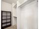 Walk-in closet with carpeted floor, shelving unit, and hanging racks at 7323 Lowell Blvd, Westminster, CO 80030