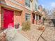 Townhome entrance featuring a red front door and low-maintenance gravel landscaping at 7323 Lowell Blvd, Westminster, CO 80030