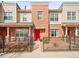 Charming townhome with brick facade, red door, and cozy front patio area at 7323 Lowell Blvd, Westminster, CO 80030