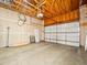 Unfinished two-car garage with an automatic door and exposed wood beam ceiling at 7323 Lowell Blvd, Westminster, CO 80030
