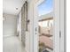 Bright hallway featuring patterned curtains, an exterior door, and neutral decor at 7323 Lowell Blvd, Westminster, CO 80030