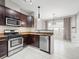 Well-equipped kitchen with stainless steel appliances and dark wood cabinets at 7323 Lowell Blvd, Westminster, CO 80030