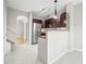 Bright kitchen with stainless steel appliances, brown cabinetry and countertops, and tile flooring at 7323 Lowell Blvd, Westminster, CO 80030
