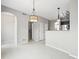 Open-plan living area featuring tile floors, an arched doorway, and views into the kitchen at 7323 Lowell Blvd, Westminster, CO 80030