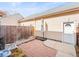 Private brick patio with a wooden fence and access to the side door of the home at 7323 Lowell Blvd, Westminster, CO 80030