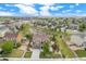Expansive aerial view of a landscaped home, showcasing the well-manicured lawn, green spaces and the neighborhood at 13326 Olive Way, Thornton, CO 80602