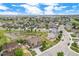 Scenic aerial view of neighborhood showcasing mature trees, pond and green spaces at 13326 Olive Way, Thornton, CO 80602