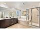 Luxurious bathroom with dual sinks, a soaking tub, and a glass-enclosed shower for a spa-like experience at 13326 Olive Way, Thornton, CO 80602