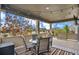 Enjoy outdoor dining on this covered patio, featuring comfortable seating and views of the neighborhood at 13326 Olive Way, Thornton, CO 80602