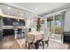 Elegant dining area with kitchen access, stylish table setting, and sliding glass doors to an outdoor space at 13326 Olive Way, Thornton, CO 80602