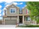 A welcoming two-story residence boasts a covered porch, convenient two-car garage, and tasteful curb appeal at 13326 Olive Way, Thornton, CO 80602