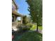 Well-manicured front yard with a covered porch, lush greenery, and healthy lawn at 13326 Olive Way, Thornton, CO 80602