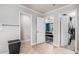 A hallway featuring doors to the ensuite bathroom, main bedroom, and walk-in closet at 13326 Olive Way, Thornton, CO 80602