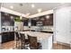 Modern kitchen featuring dark cabinetry, stainless steel appliances, granite countertops and an island with pendant lighting at 13326 Olive Way, Thornton, CO 80602