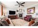 Inviting living room featuring a cozy fireplace, stylish decor, and comfortable seating arrangement at 13326 Olive Way, Thornton, CO 80602