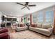 Bright living room featuring hardwood floors, neutral walls, comfortable seating and natural light from large windows at 13326 Olive Way, Thornton, CO 80602