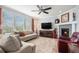 Comfortable living room with plush seating, a fireplace, and large windows for ample natural light at 13326 Olive Way, Thornton, CO 80602