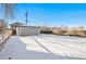 Spacious backyard with detached garage and snowy ground at 5231 Quitman St, Denver, CO 80212