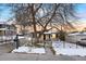 House exterior with snow-covered yard and wrought iron fence at 5231 Quitman St, Denver, CO 80212