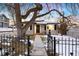 Charming home exterior with a well-maintained yard and decorative black metal fence at 5231 Quitman St, Denver, CO 80212