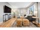 Well-lit living room with hardwood floors, comfortable seating, and modern decor at 5231 Quitman St, Denver, CO 80212