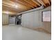 Unfinished basement with exposed ceiling beams and concrete walls at 11867 Elk Head Range Rd, Littleton, CO 80127