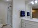 Well-lit bathroom featuring modern fixtures, a sleek vanity, and a glass-enclosed shower at 11867 Elk Head Range Rd, Littleton, CO 80127
