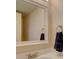 Bright bathroom with a large mirror, modern sink, and a convenient towel rack at 11867 Elk Head Range Rd, Littleton, CO 80127